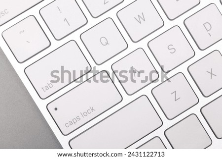 Internet shopping. Computer keyboard on grey background, top view
