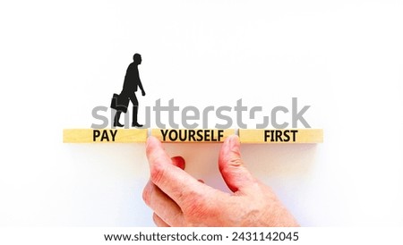 Pay yourself first symbol. Concept words Pay yourself first on beautiful wooden blocks. Beautiful white table white background. Businessman hand. Business and pay yourself first concept. Copy space.