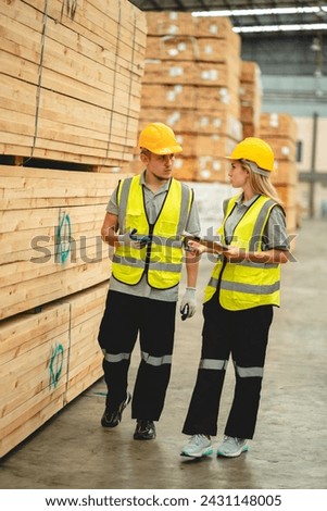 Engineer team standing walking in warehouse examining hardwood material for wood furniture production, Worker check stock, Technician man and woman working on quality control in lumber pallet factory
