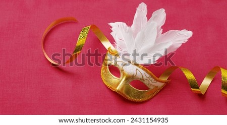 Beautiful carnival masks with golden ribbon, on a pink background. Concept for the holiday Purim, Mardi Gras. View from above