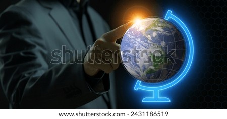 Businessman pointing his finger to planet earth model on blue neon stand. Concept for environment, study and education.
