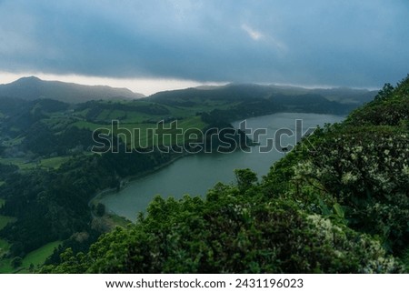 View of the Lake Furnas (Lagoa das Furnas) on Sao Miguel Island, Azores, Portugal from the Pico do Ferro scenic viewpoint. Tranquil scene of the lake in a volcanic crater Royalty-Free Stock Photo #2431196023