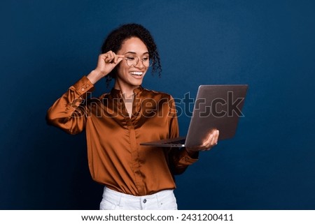 Photo of successful marketer lady using netbook reading letters email from business partners isolated over blue color background