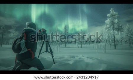 Photographer Capturing the aurora borealis in Snowy Wilderness with Northern Lights