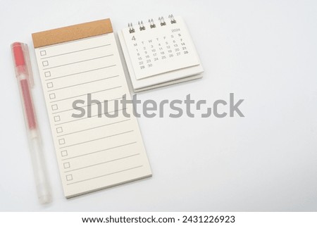 Blank Check list or Empty small notepad with checkbox and Simple desk calendar for APRIL 2024. Blank checklist for text. Copy Space. Royalty-Free Stock Photo #2431226923
