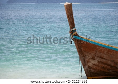 Wooden boat with blue sea on the beach