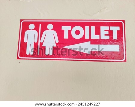 arrow symbol for entering the women's or men's toilet in red