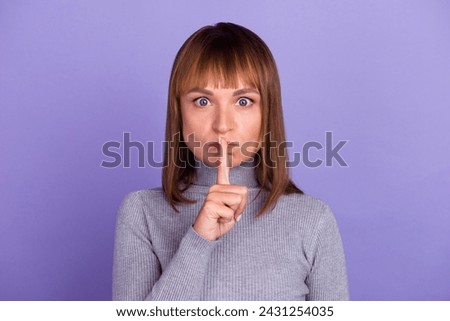 Portrait of young attractive brunette woman with sincere emotions wearing casual shirt for mockup isolated on bright background with copy space and showing shh gesture. Royalty-Free Stock Photo #2431254035