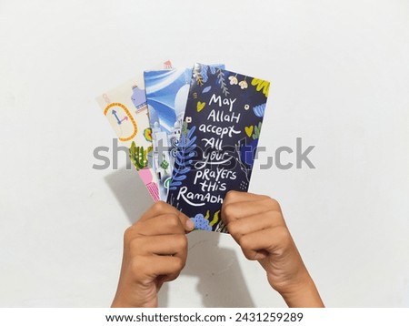Amplop hari raya or THR or Angpao or Envelopes filled with money to give to children during Eid al-Fitr. Eid celebration.  Royalty-Free Stock Photo #2431259289