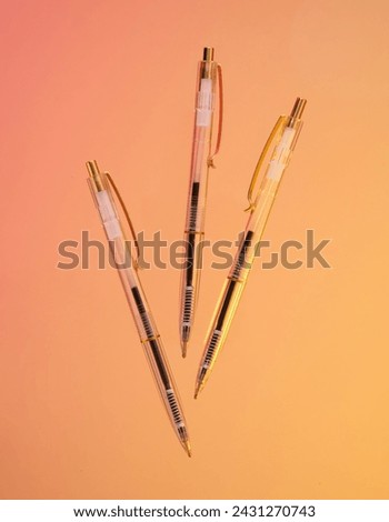 Three pens and office supplies. Composition of bright office supplies. Royalty-Free Stock Photo #2431270743