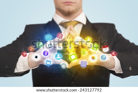 Hands creating a form with colorful mobile app icons in the center 