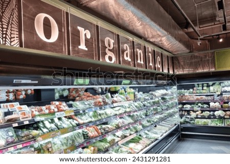 Organic signage on supermarket aisle that retails fresh, healthy and pesticide free vegetables and fruits