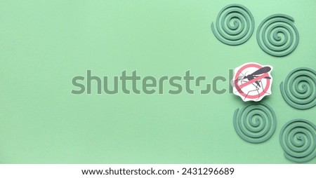 Mosquito spirals and anti insect sign on green background with space for text