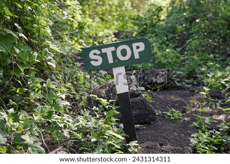 Stop sign in the highland forest on the Santa Cruz galapagos island, Ecuador. Protect nature and wildlife like the breeding turtles.