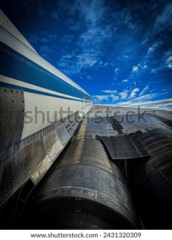 Photo of the wing of an airplane in the right sky. The picture shows an aircraft engine and the wing of an airplane
