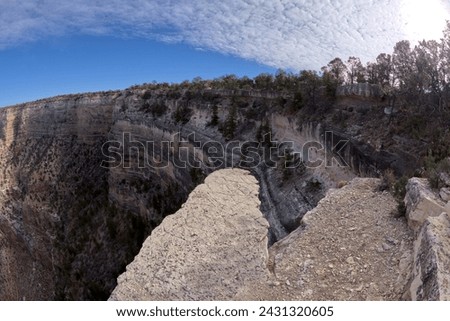 A narrow rock outcrop extending over the cliffs just west of The Abyss overlook at Grand Canyon Arizona. Royalty-Free Stock Photo #2431320605