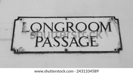 Old road sign Road Sign on a yellow brick wall giving its location as "Longroom Passage."