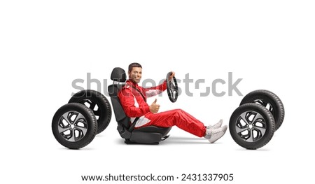 Racer in a car seat holding a steering wheel and gesturing a thumb up sign isolated on white background