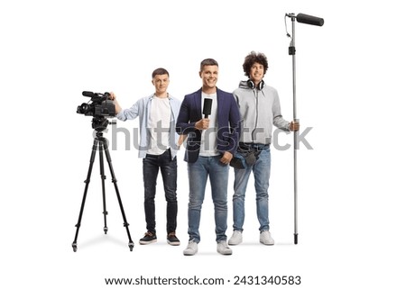 Man with a microphone and a team of boom and camera operators with recording equipment isolated on white background Royalty-Free Stock Photo #2431340583