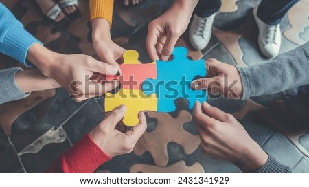 Hands Assembling Jigsaw Puzzle Teamwork and Strategy Concept puzzle and hands Royalty-Free Stock Photo #2431341929
