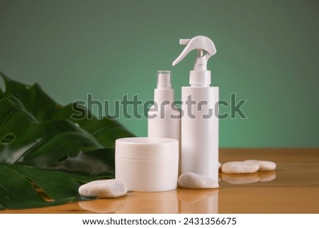 set of cosmetic bottles and blank label for branding on wooden background. mockup for your product or design.