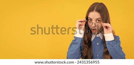 Just curious. Curious girl in eyeglasses. Nerdy-looking kid yellow background. Back to school. Child face, horizontal poster, teenager girl isolated portrait, banner with copy space.