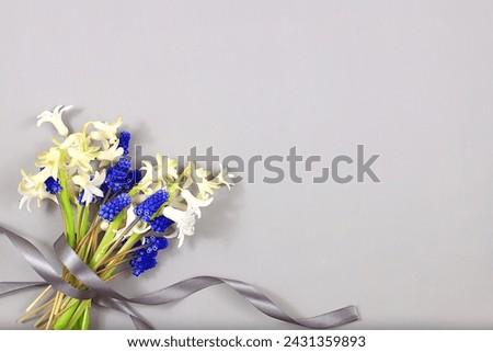 Abstract floral composition, still life, spring background or banner, Beautiful blooming hyacinths and muscari on a light background.holiday concept. Card for Mother's Day, Women's Day,  Royalty-Free Stock Photo #2431359893