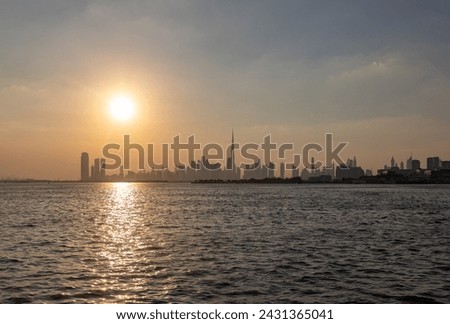 A picture of Downtown Dubai at sunset, with the Burj Khalifa towering all high rises.