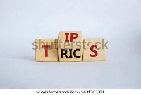 Tips and Tricks symbol. Wooden cubes with words Tricks and Tips. Beautiful white background. Business and Tips and Tricks concept. Copy space