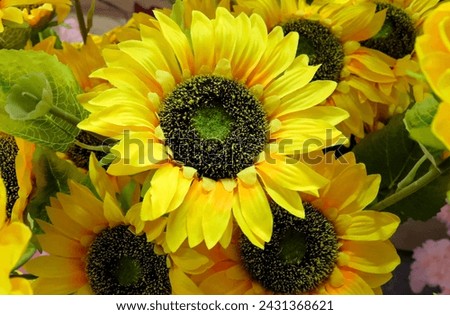 Close-up yellow artificial sunflower. Fake flowers that look real