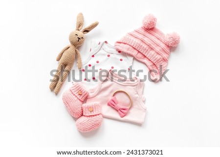 Set of baby girl dress - bodysuit with knitted hat and boots, top view. Kids clothing flat lay.