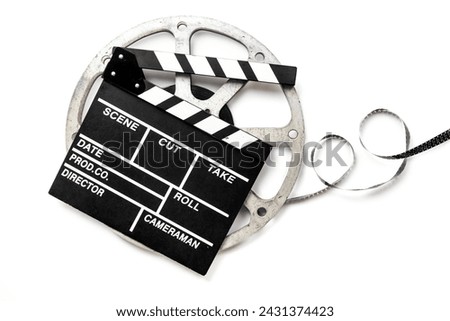 Film reels and clapperboard - cinema and filmmaker concept.
