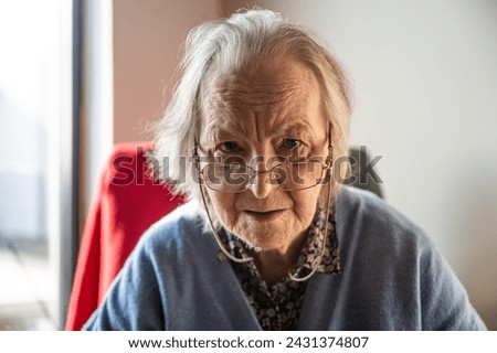 Portrait of an 85 yo white grandmother sitting, Tienen, Flemish Brabant, Belgium Royalty-Free Stock Photo #2431374807