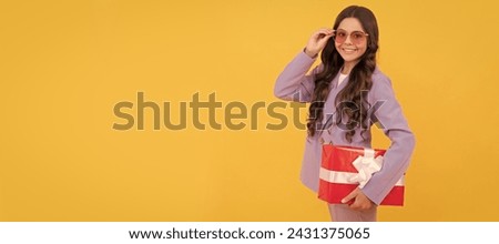sale and discount. surprise for her. boxing day. cheerful kid with present box. Kid girl with gift, horizontal poster. Banner header with copy space.