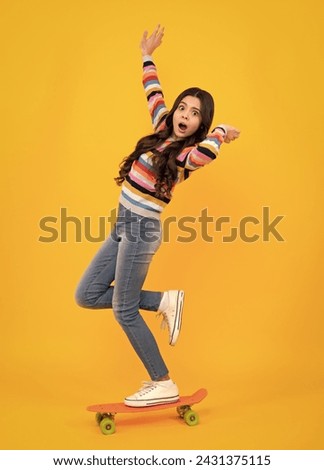 Amazed teenager. Fashion teenage lifestyle, beautiful teen girl with skateboard isolated on studio background. Excited teen girl.