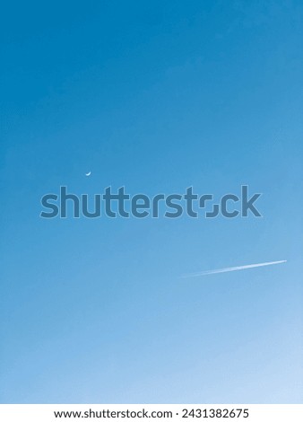 That picture must be absolutely stunning! An airplane flying against the backdrop of a daytime moon is a mesmerizing sight.