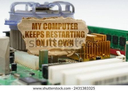 On the computer motherboard there is a cardboard with the inscription - My computer keeps restarting on its own. Computer repair concept.