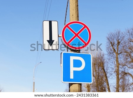 A street sign with a no parking sign above it, indicating restricted parking in the area.