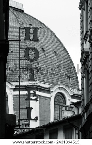 Hotel sign in Florence with the Cathedral of Santa Maria del Fiore in the background