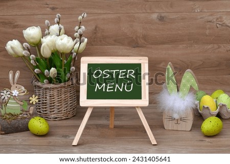 A bouquet of tulips with Easter eggs and the text Easter menu on a blackboard. German inscription translated means Easter menu.