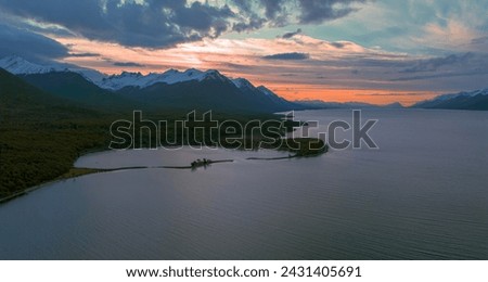 Beautiful sunset on Lake Fagnano with the snowy mountains in the background