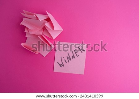Lottery ticket with the word winner on a colored background near sheets of paper. Winner concept
