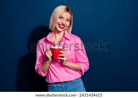 Portrait of satisfied cute woman with bob hairdo wear stylish shirt hold cup of latte at work isolated on dark blue color background