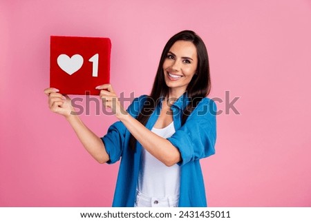 Photo of lovely nice girl with straight hairdo dressed blue shirt demonstrate one social media like isolated on pink color background