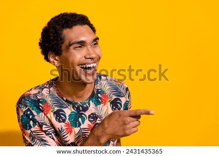 Photo of young laughing guy wearing t shirt free time at comic stand up show direct finger empty space isolated on yellow color background