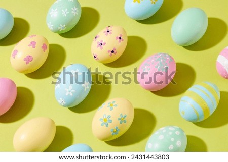 Colorful Easter Egg decorated on a pastel paper banner background. Advertising photo. Easter eggs have many meanings: fertility, proliferation and good luck