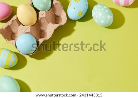 Happy Easter background with colorful eggs decorated on green background. Top view, blank space for design or add meaningful wishes