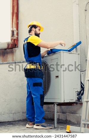 Experienced repairman contracted to recondition external air conditioner starting task. Qualified engineer wearing protective gear preparing to mend malfunctional outdoor hvac system Royalty-Free Stock Photo #2431447587
