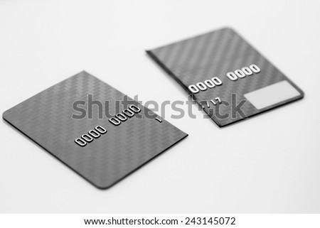 closeup of broken credit card, captured with a small depth of field. Black and white picture