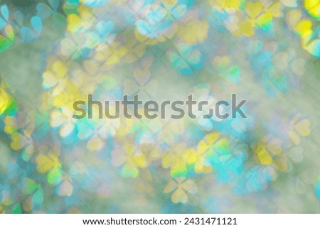 Floral figured Bokeh in pastel Hues, Colorful Abstract bokeh background, natural flare from lights, blurred clover leaves shapes texture as holiday backdrop, celebration photo with optical effect